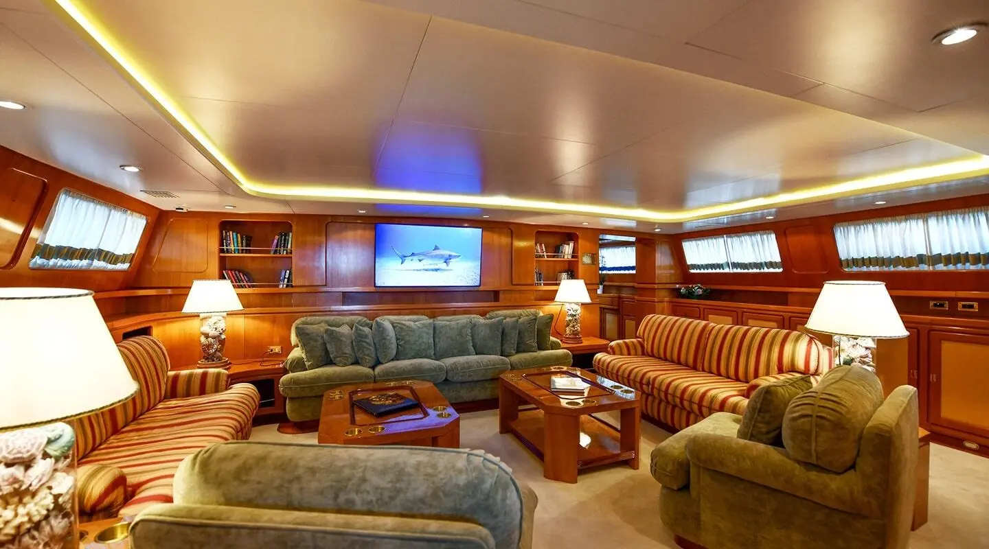 Tamarita yacht saloon interior with plush tan leather seating and wood panels