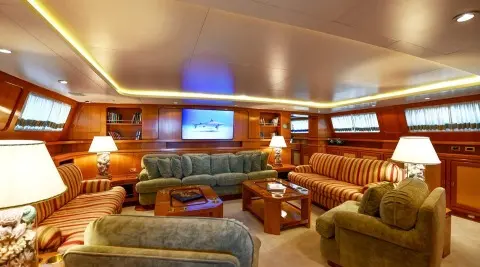 Tamarita yacht saloon interior with plush tan leather seating and wood panels