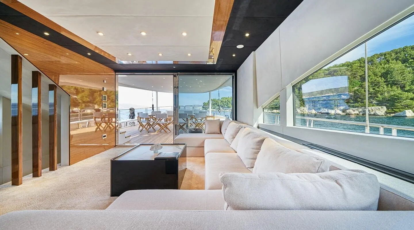 Acapella yacht salon reveals white seating, glass windows, and wooden accents