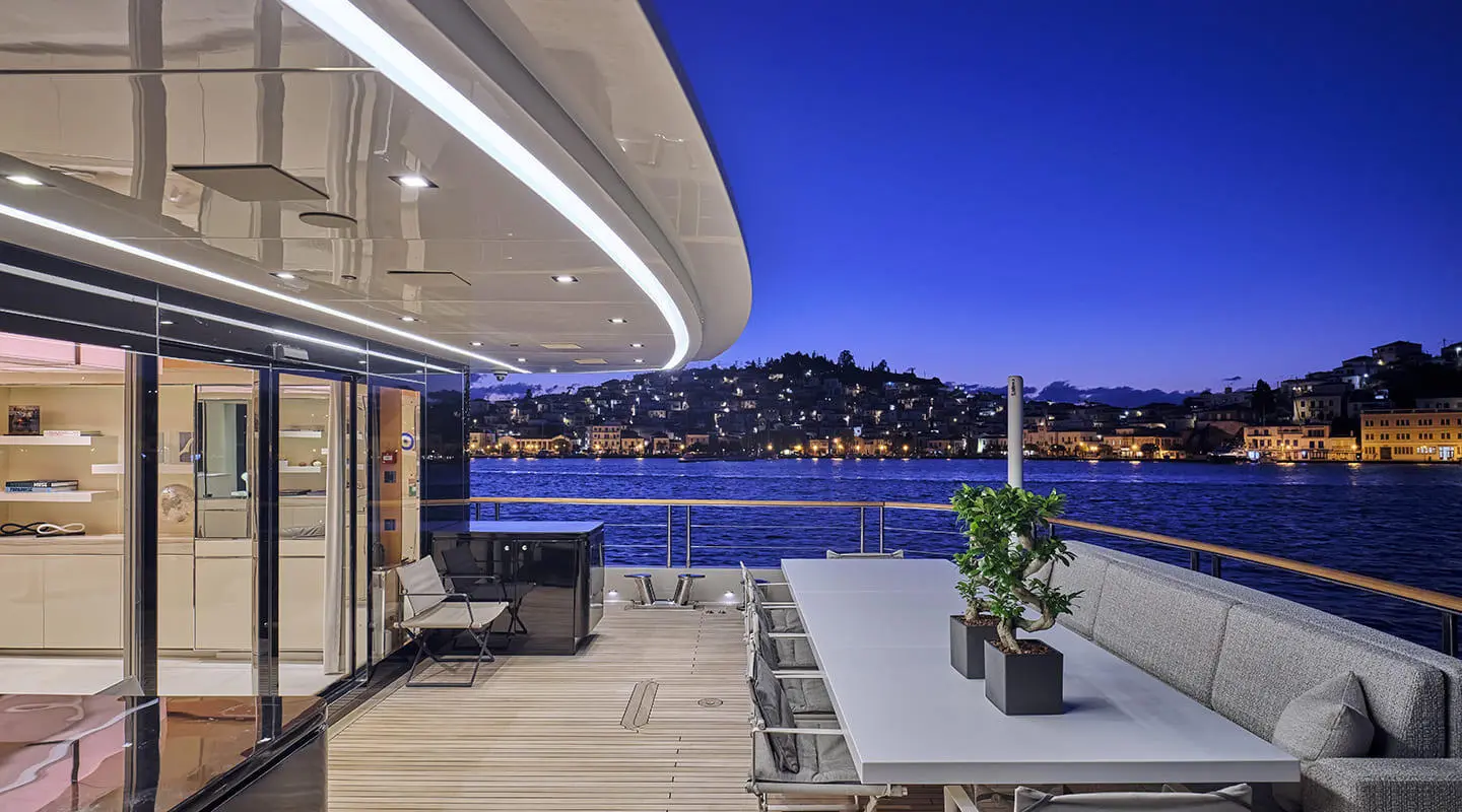 La Pellegrina 1 yacht lounge area with seating and view of night harbor