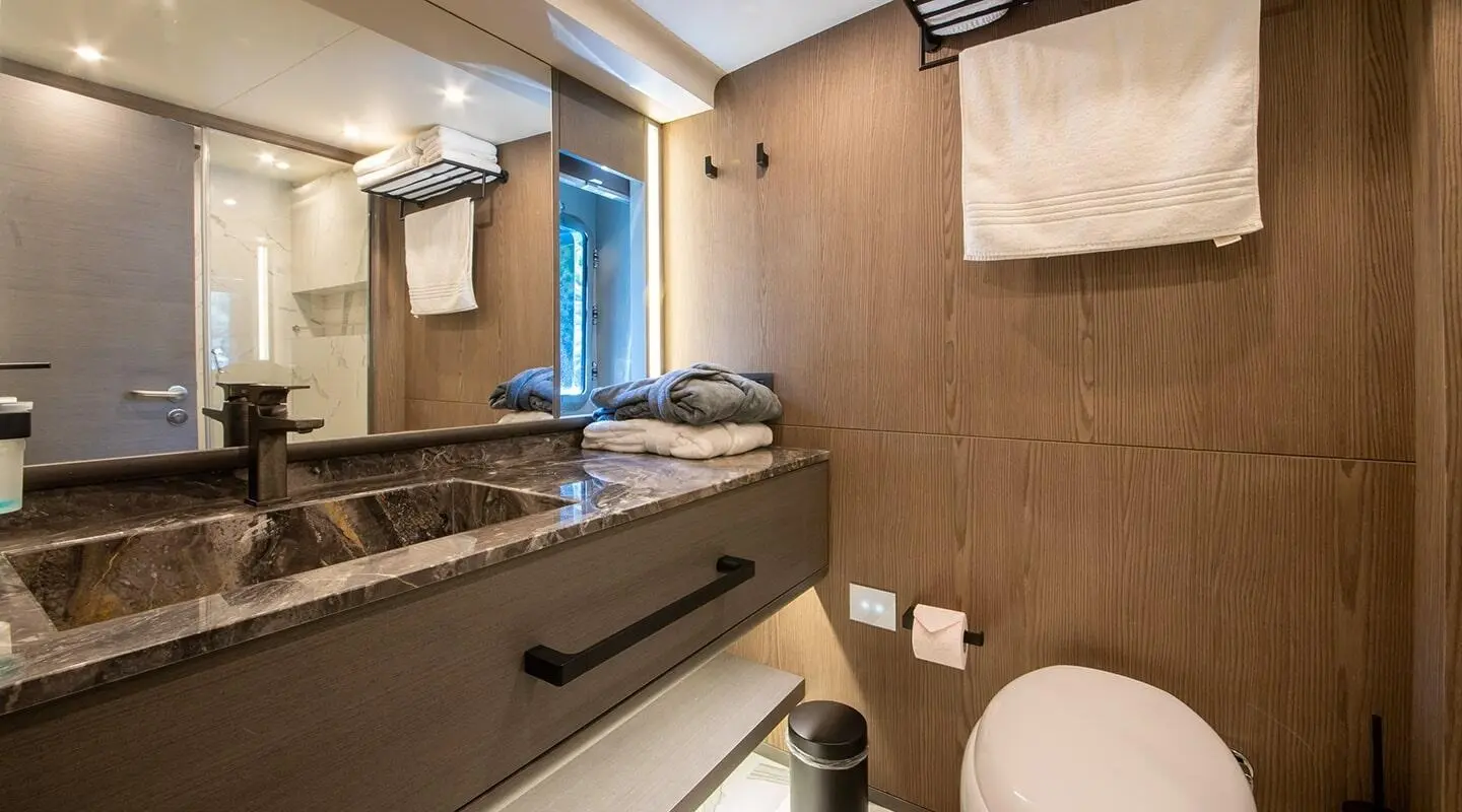 Luxurious yacht bathroom on Good Life with marble sink and blue accents