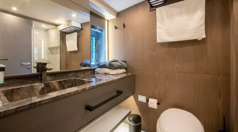 Luxurious yacht bathroom on Good Life with marble sink and blue accents