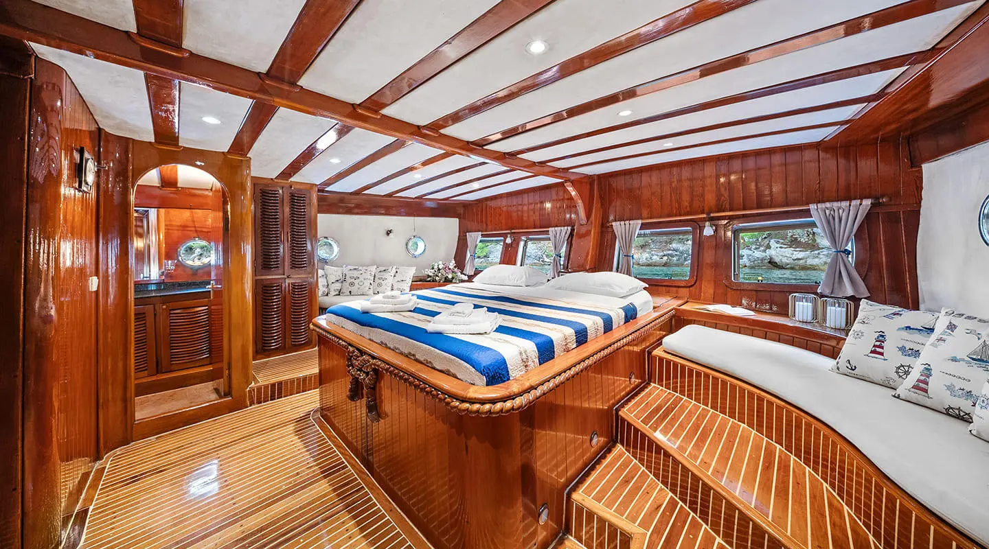 Wooden interior with a master bed on a luxury gulet yacht Eleganza