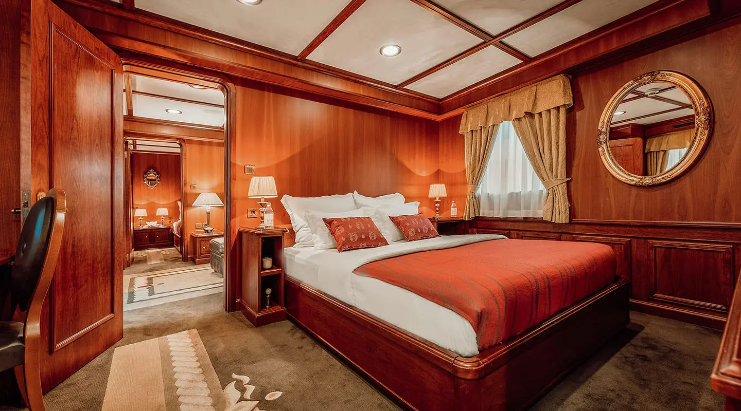Seagull II yacht cabin with two beds, wooden walls, and porthole window