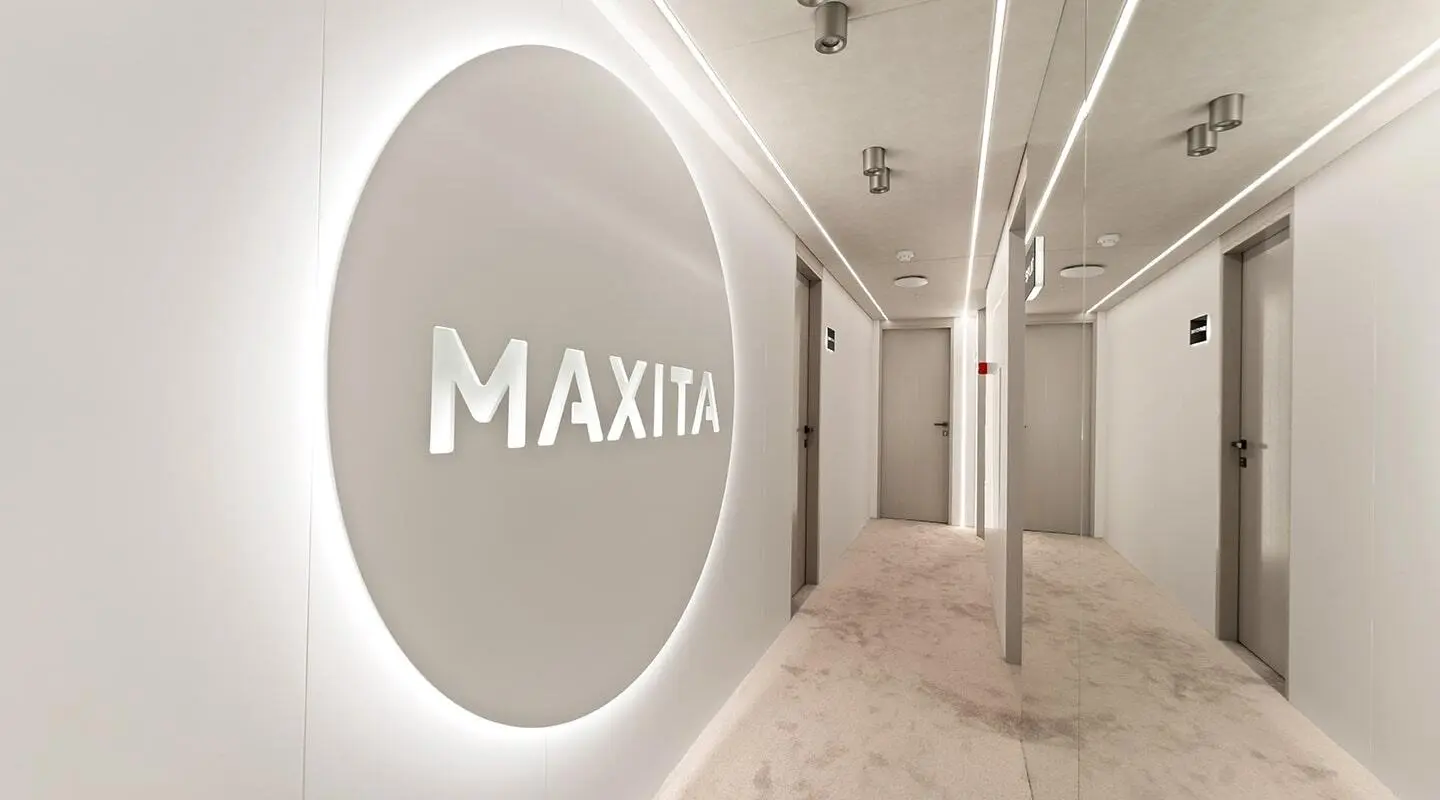 Interior of Maxita yacht with circular logo wall and light gray corridor