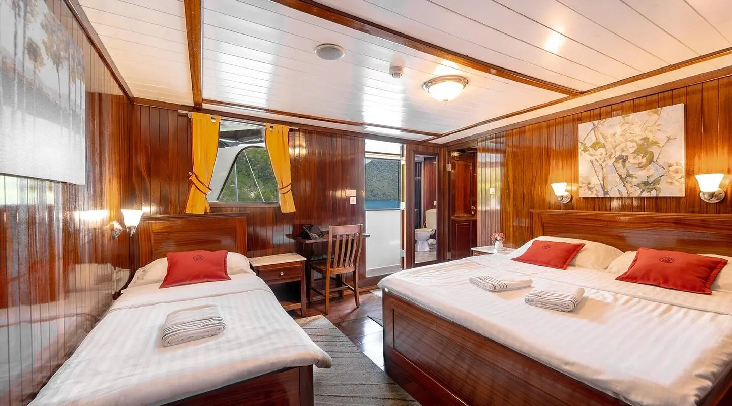 Interior of Cesarica gulet: twin cabin with two single beds and wood paneling