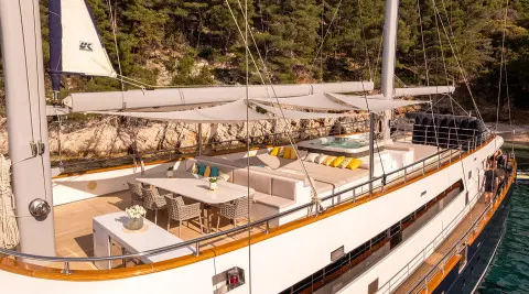 Dalmatino yacht outdoor sundeck with seating and dining area under sunshade