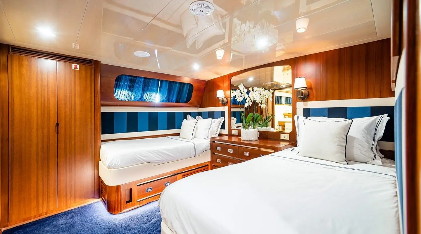 Interior of Wind Of Fortune yacht guest cabins with beds and porthole viewing