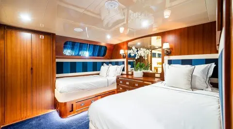 Interior of Wind Of Fortune yacht guest cabins with beds and porthole viewing