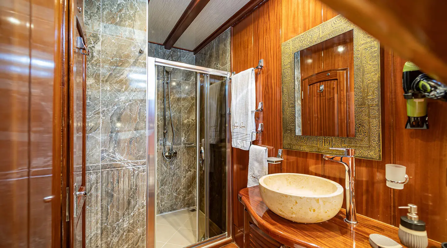Lycian Queen luxury yacht bathroom with marble shower and stone sink