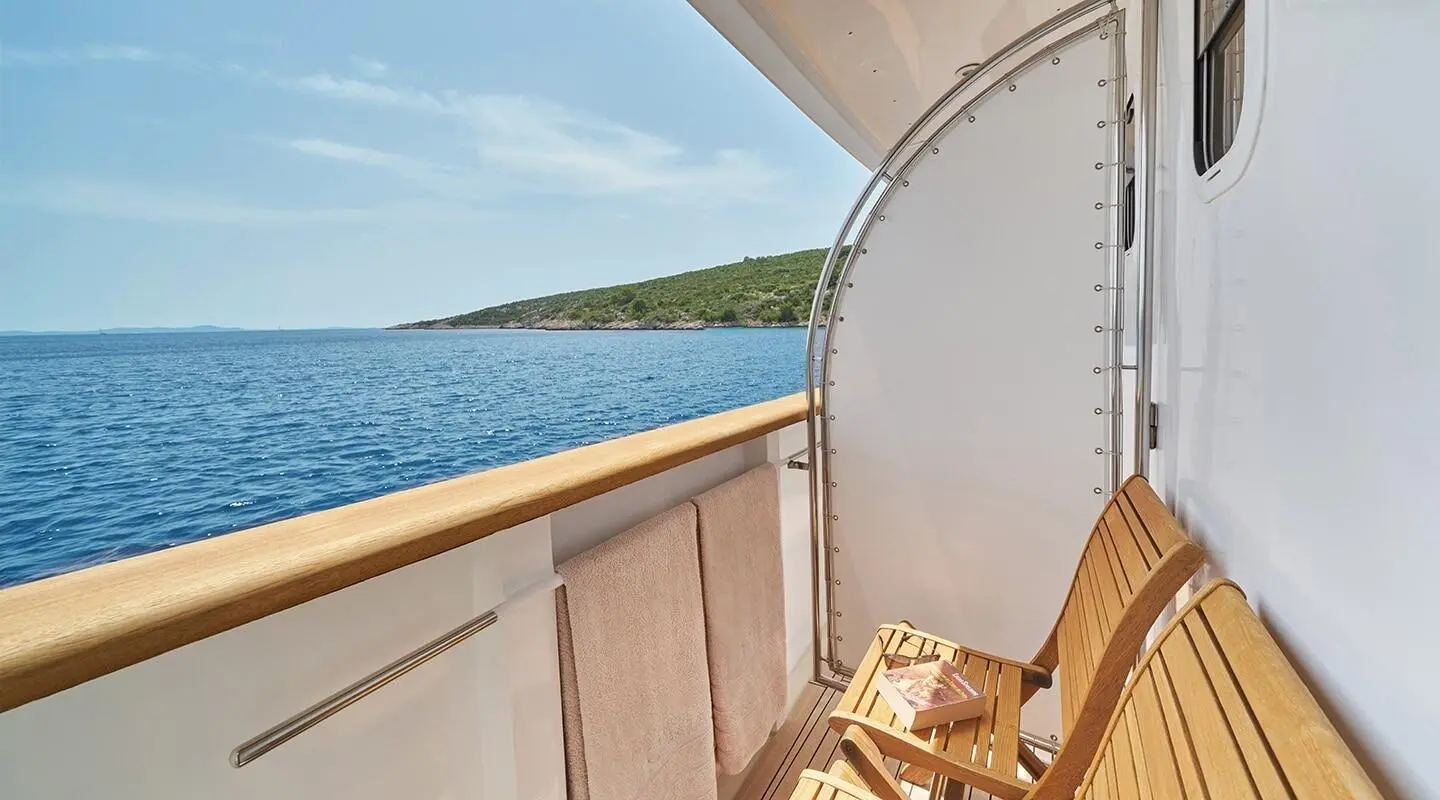 Yacht La Perla balcony view over calm sea with railing and water