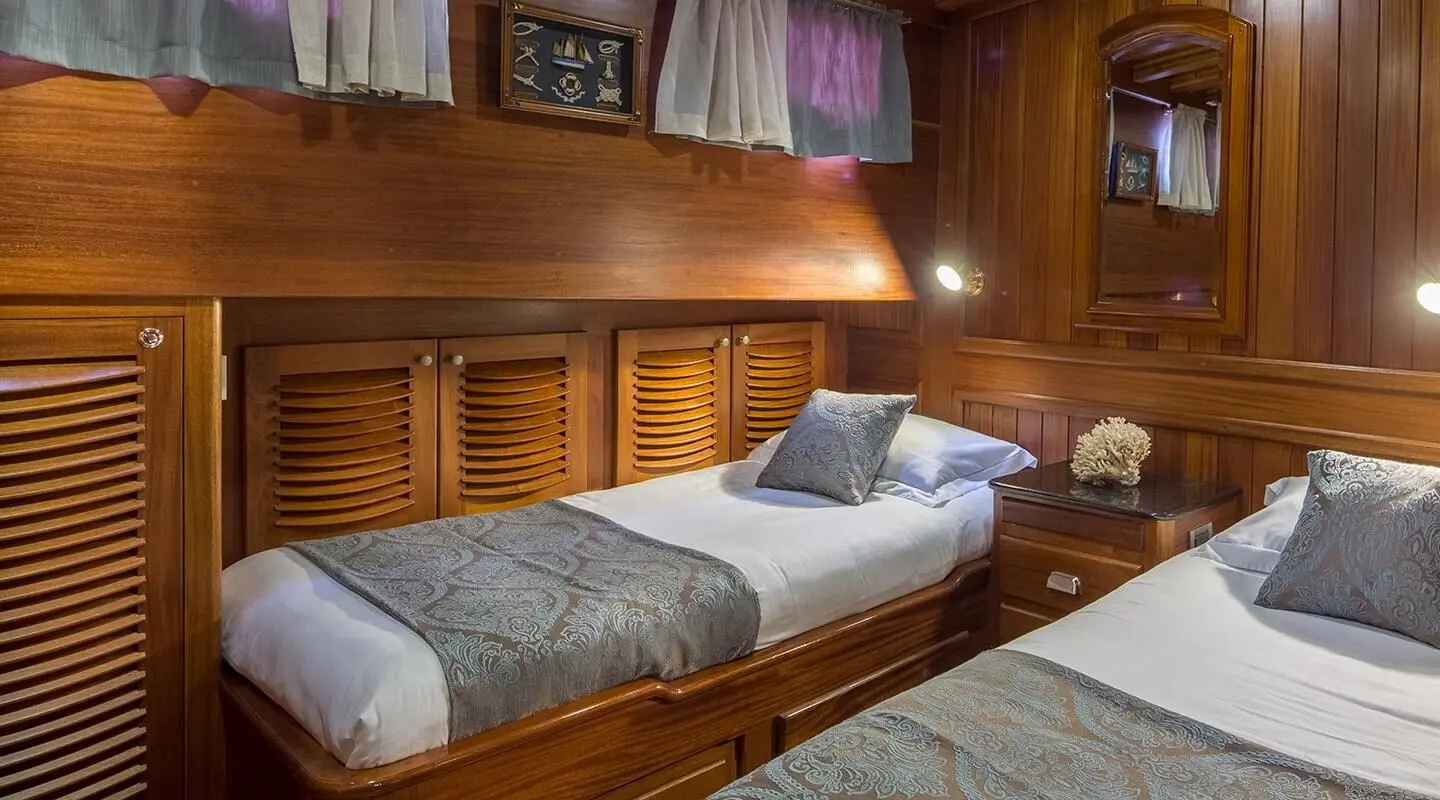 Carpe Diem 7 luxury gulet interior with wooden bunk beds and dim lighting