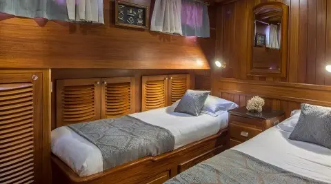 Carpe Diem 7 luxury gulet interior with wooden bunk beds and dim lighting