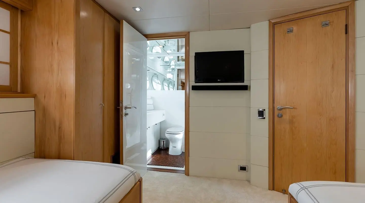 Interior of yacht Brooklyn with bed, wardrobe, and door to balcony