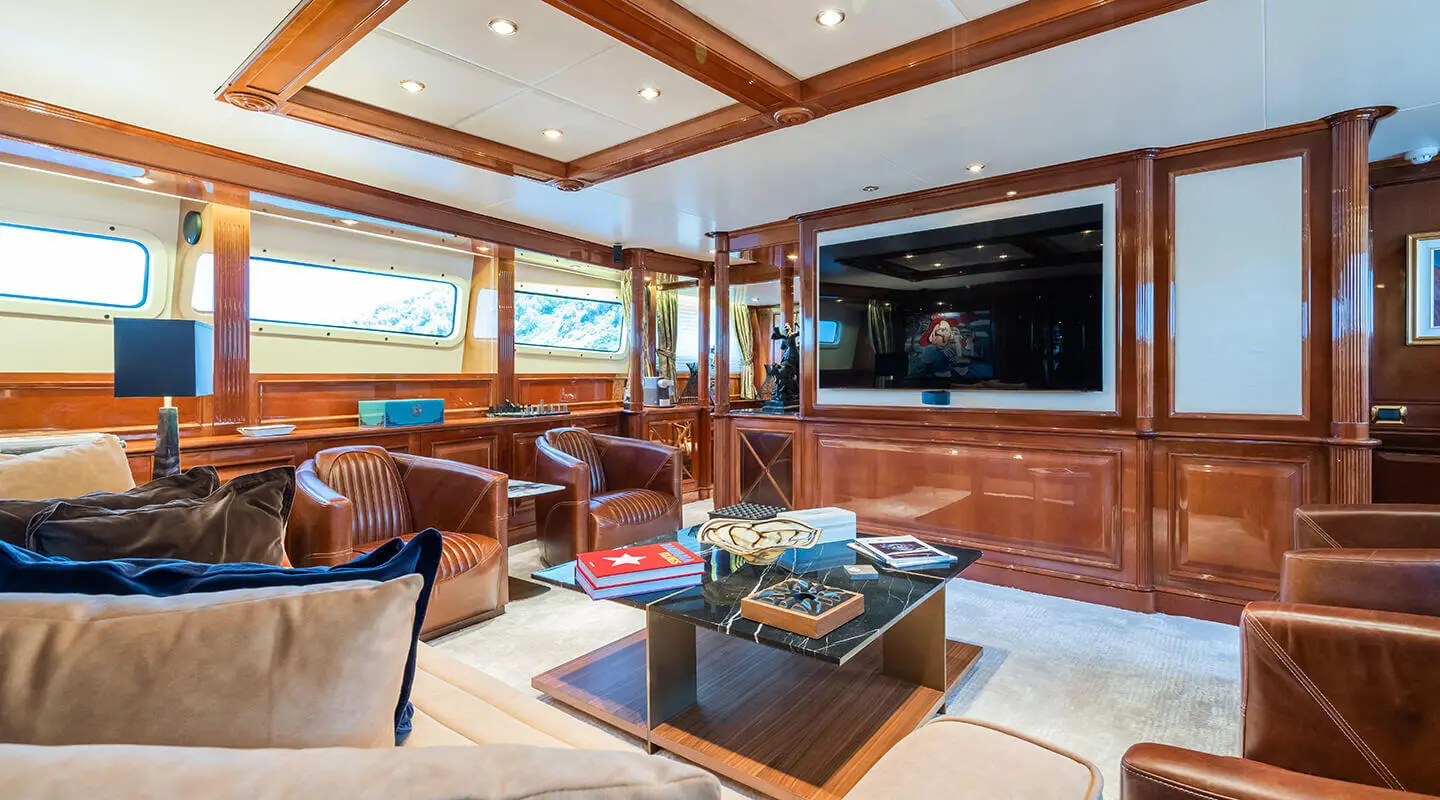 Amadea yacht saloon with wooden panels and large TV screen