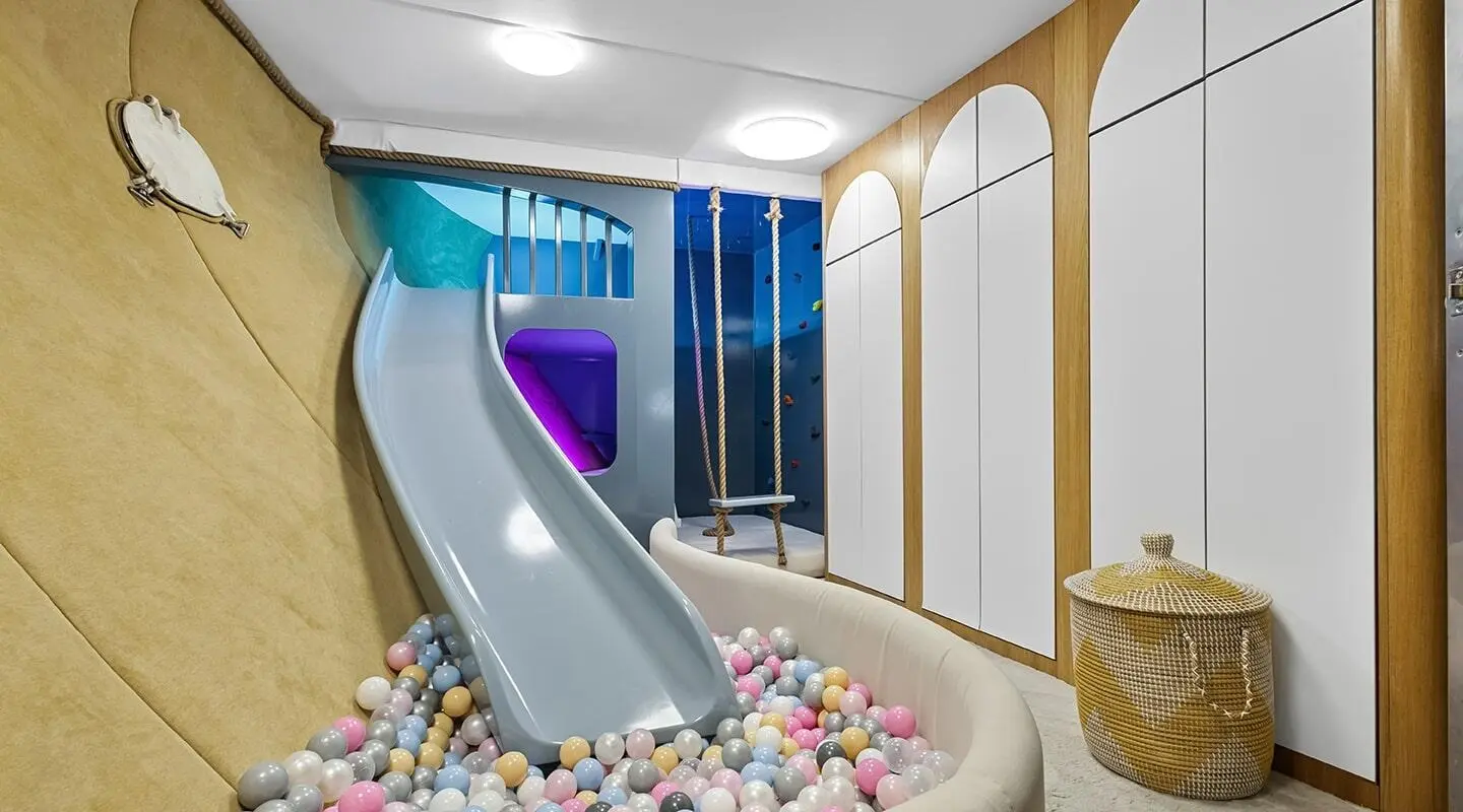 Indoor play area with a slide and colorful ball pit on a luxury yacht