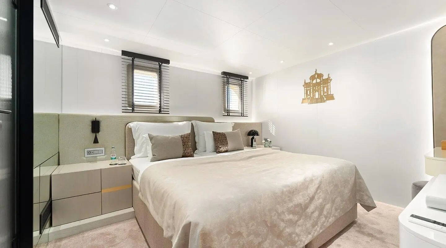Maxita luxury yacht bedroom with king bed, neutral tones, and stylish lighting