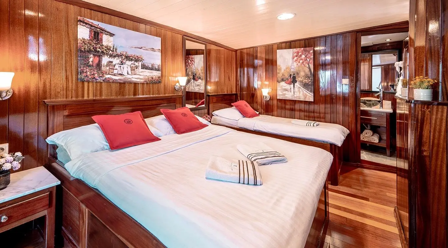 Cesarica luxury yacht charter in harbor at sunset, warm cabin glow