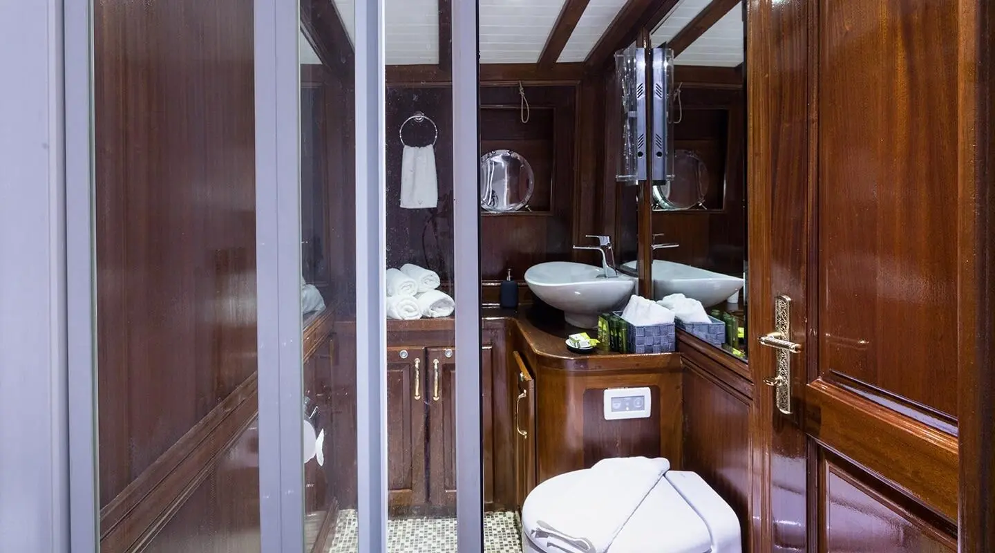Interior of Grace 1 yacht bathroom with wooden cabinets and tiled floor