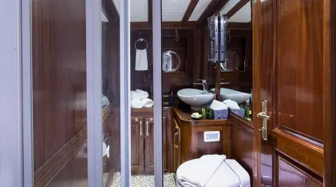 Interior of Grace 1 yacht bathroom with wooden cabinets and tiled floor