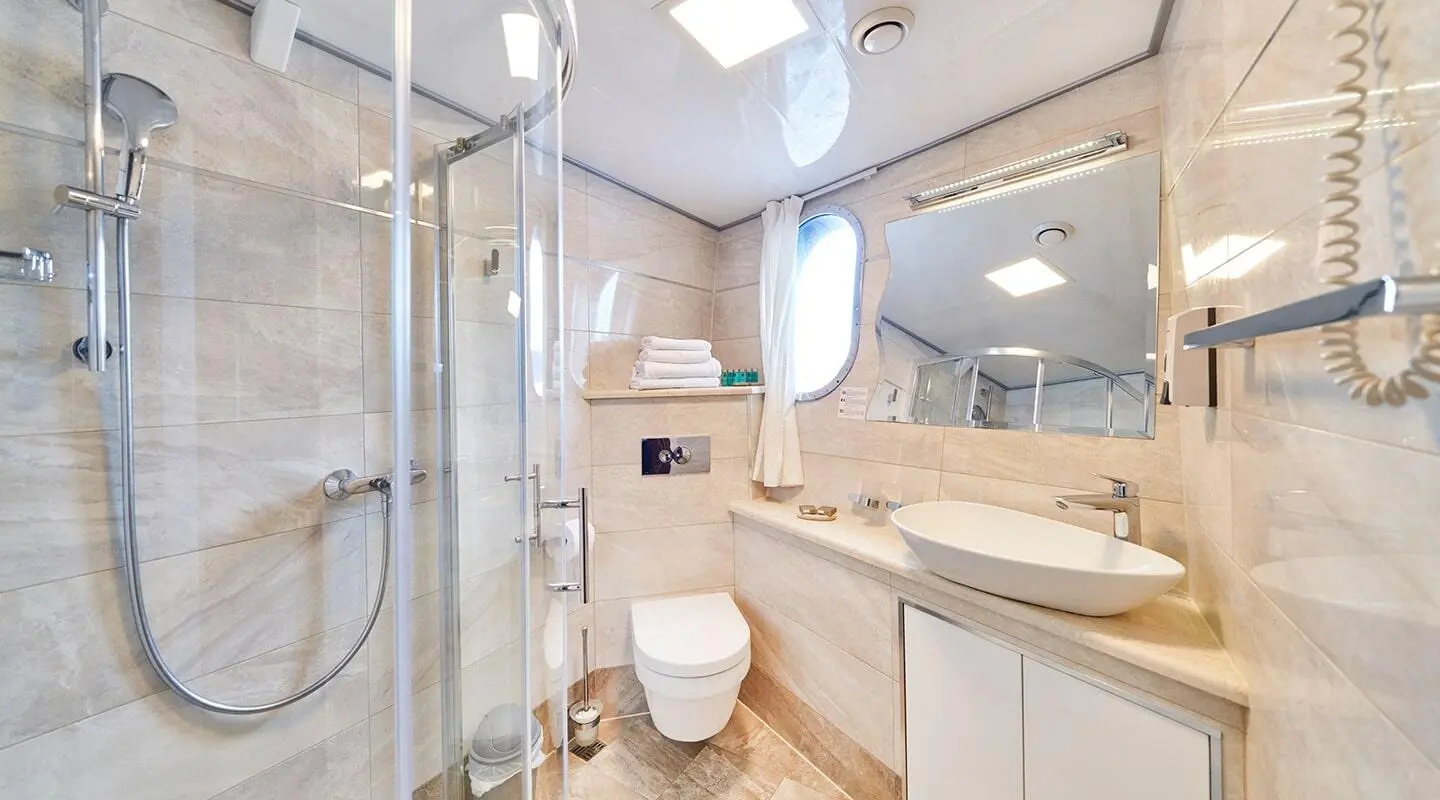 Casablanca yacht interior: sleek marble counters, white cabinets, and bathroom with glass shower