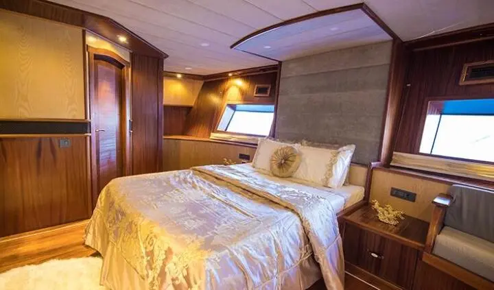 Nevra Queen master cabin with king bed and ensuite bathroom visible