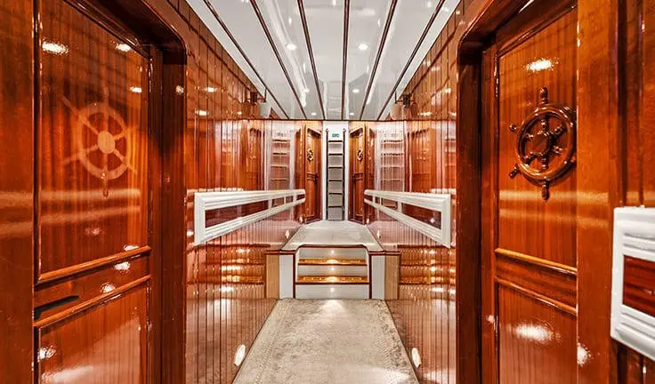 Midship cabin on Esma Sultan yacht with wooden berths and warm lighting