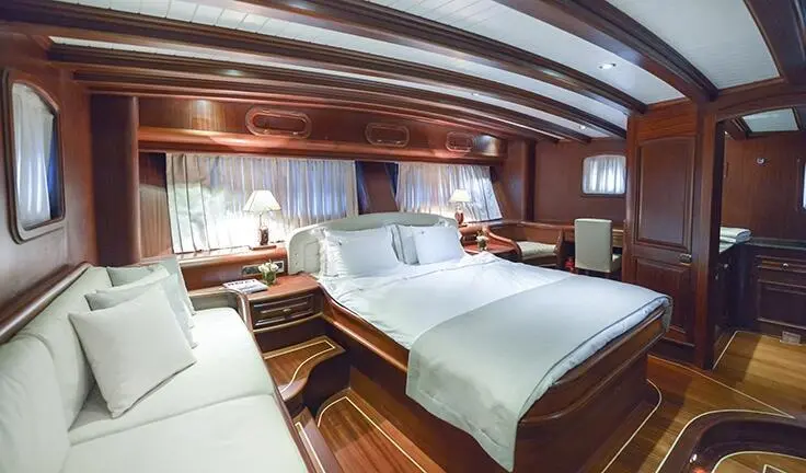 Master cabin on Lady Christa with king bed, ensuite visible, wood trim, soft lighting