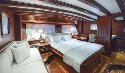 Master cabin on Lady Christa with king bed, ensuite visible, wood trim, soft lighting