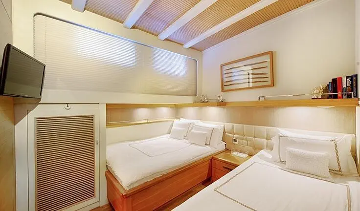 Cobra King cabin interior with twin beds, soft lighting, and wood accents