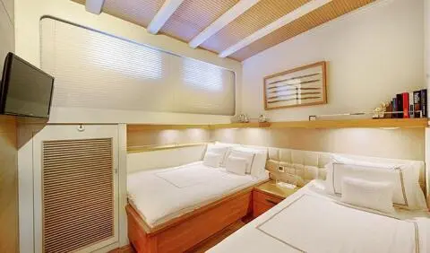 Cobra King cabin interior with twin beds, soft lighting, and wood accents