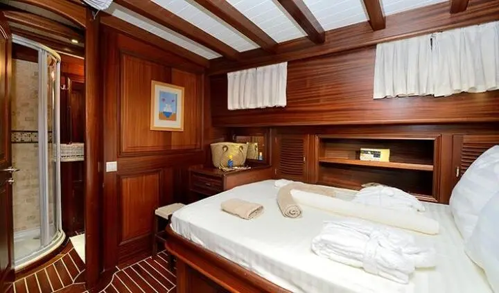 Cozy cabin interior of a yacht with wooden walls and two single beds