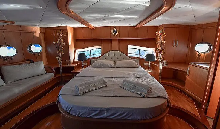 Blu Dream cabin with large bed, wooden panels, and ensuite door visible