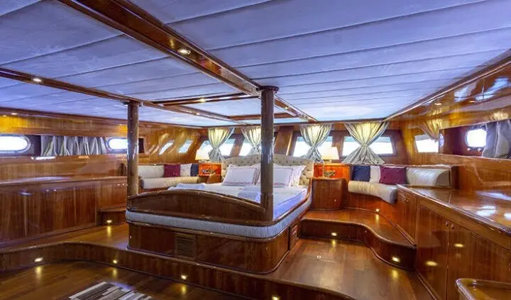 Master cabin with king bed and ensuite bathroom aboard Silver Moon yacht at dusk