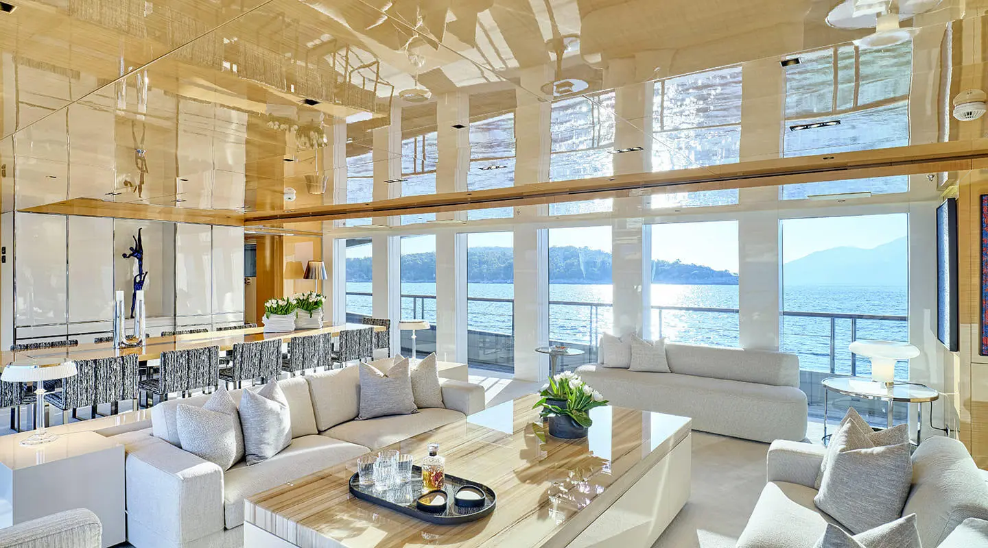 La Pellegrina 1 yacht interior lounge with large windows and sea view at sunset