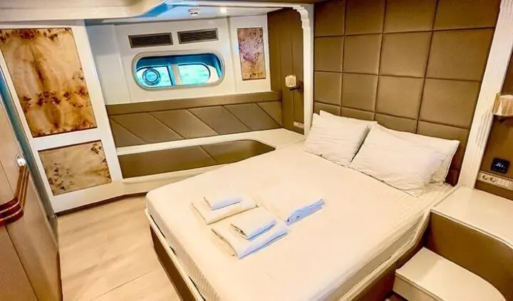 Master cabin with king bed and en-suite, wood tones, neat linens