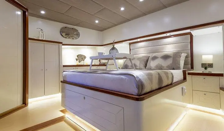 Interior view of Grand Sailor cabin with bed, cabinets, and overhead lighting