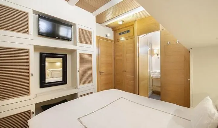 Cobra King master cabin with king bed, ensuite door and wood paneling