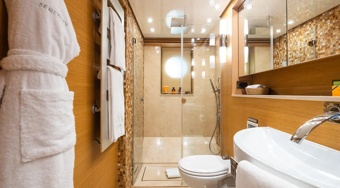 Exterior of Serenity yacht with wooden deck, seating, and ocean backdrop