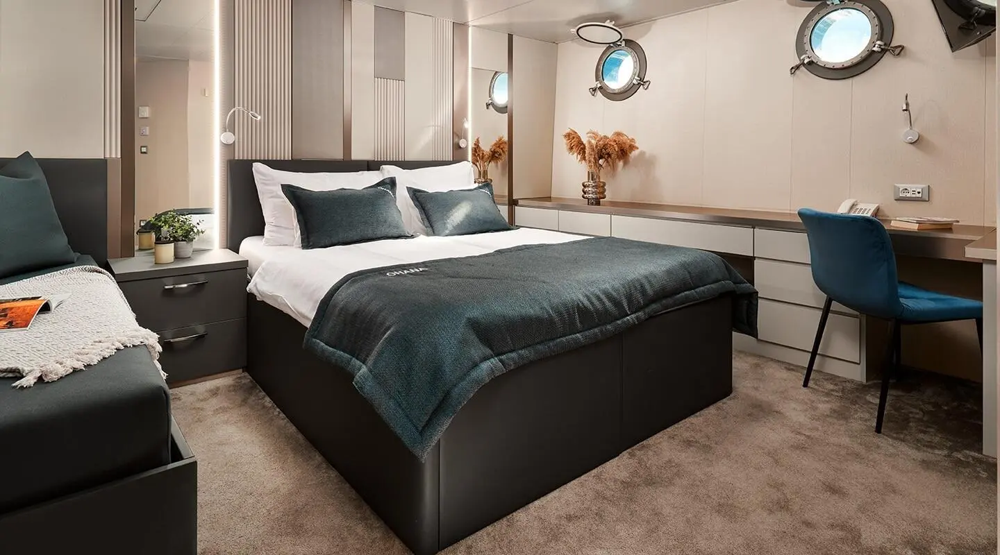 Ohana luxury yacht bedroom with blue bedding and bedside lamps