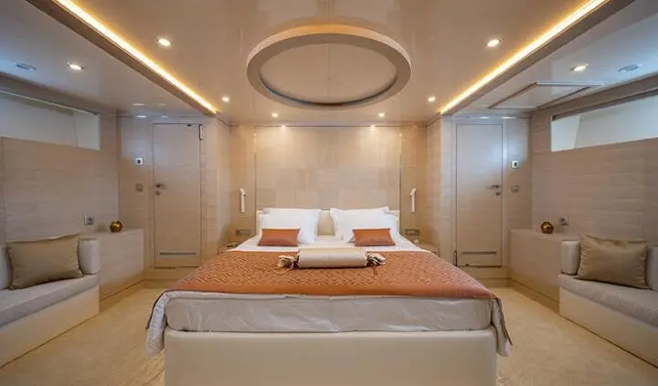Love Story yacht cabin with king bed, ensuite, soft lighting, circular ceiling fixture