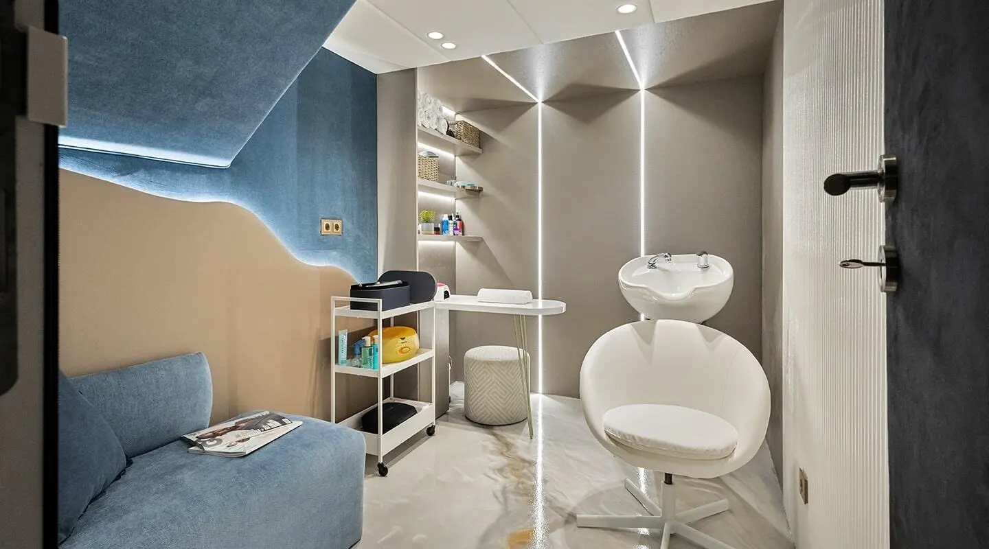 Interior view of a modern yacht with a seating area and white lounge chair