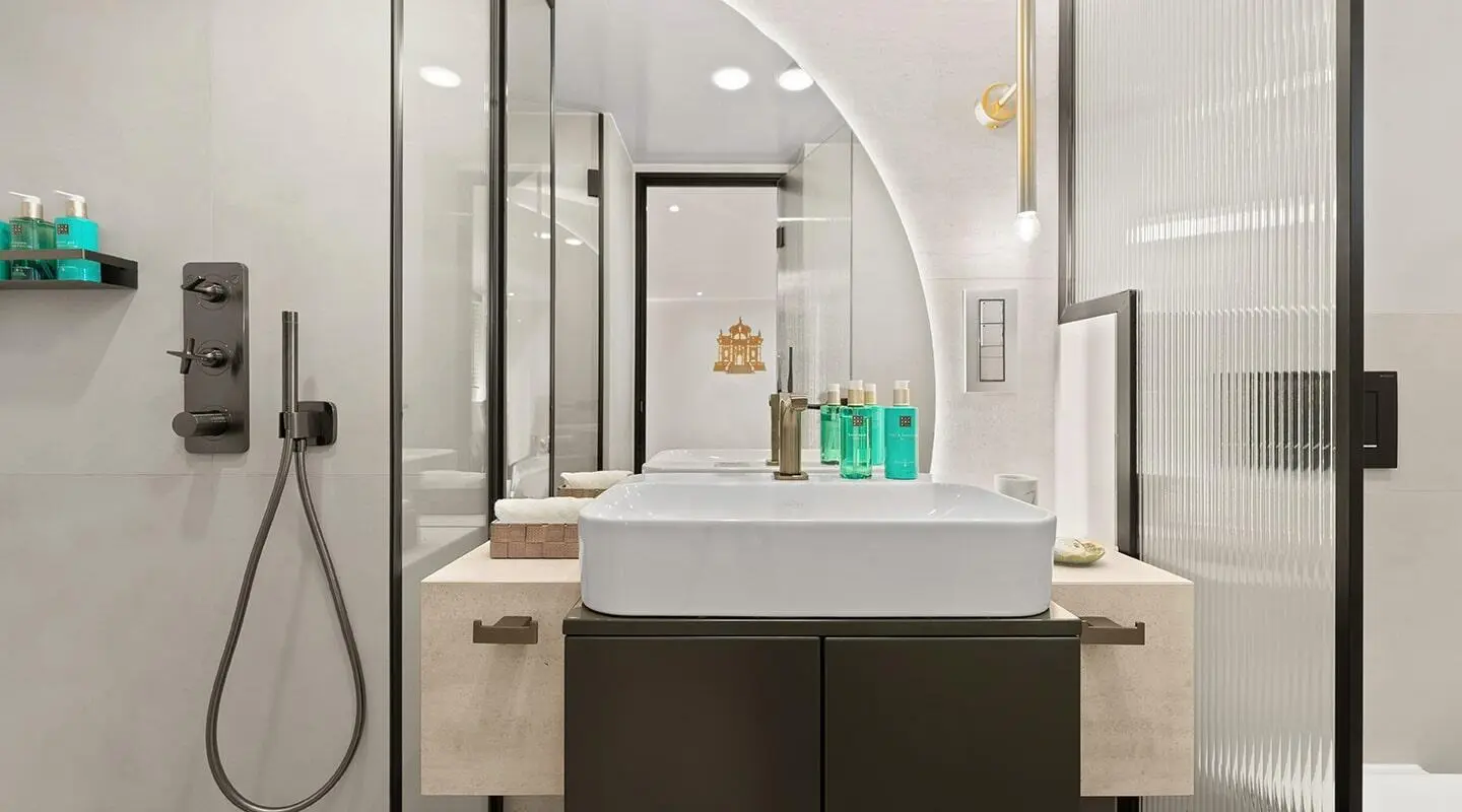 Luxurious yacht bathroom interior with sink, mirrors, and toiletries on countertop
