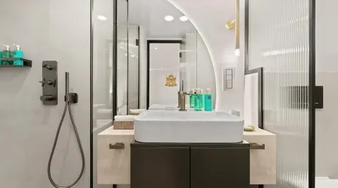 Luxurious yacht bathroom interior with sink, mirrors, and toiletries on countertop