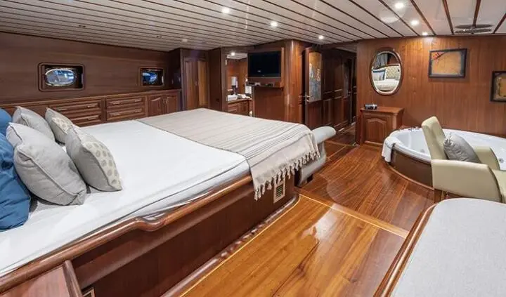 Master cabin aboard Bedia Sultan with king bed, wooden panels, ensuite glance