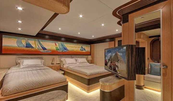 Twin cabin with two queen beds on Meira yacht, warm wood interior