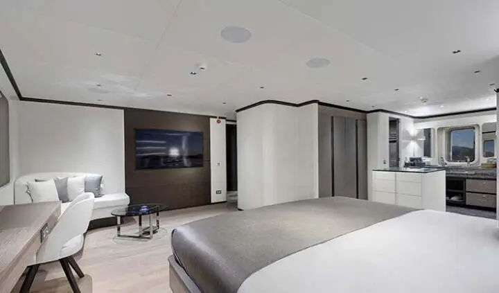 Master cabin with king bed, ensuite, neutral tones, built-in storage, and seating