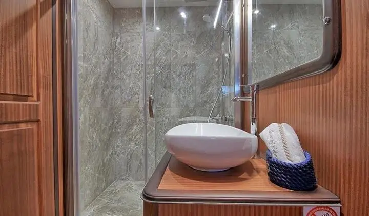 Queen Of Salmakis master cabin with king bed and ensuite visible
