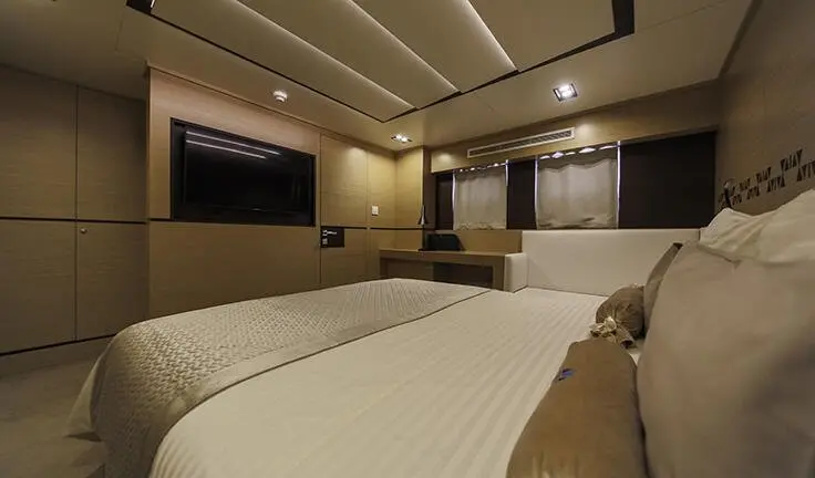 Master cabin with king bed, ensuite visible on Omnia yacht during charter