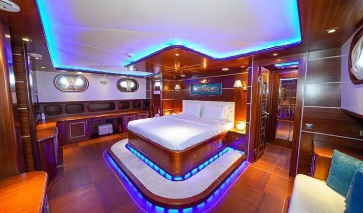 Master cabin on La Bella Vita yacht with king bed and ensuite visible